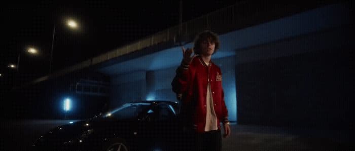 a man standing next to a car in the dark