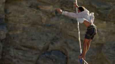 a woman on a rope high up in the air