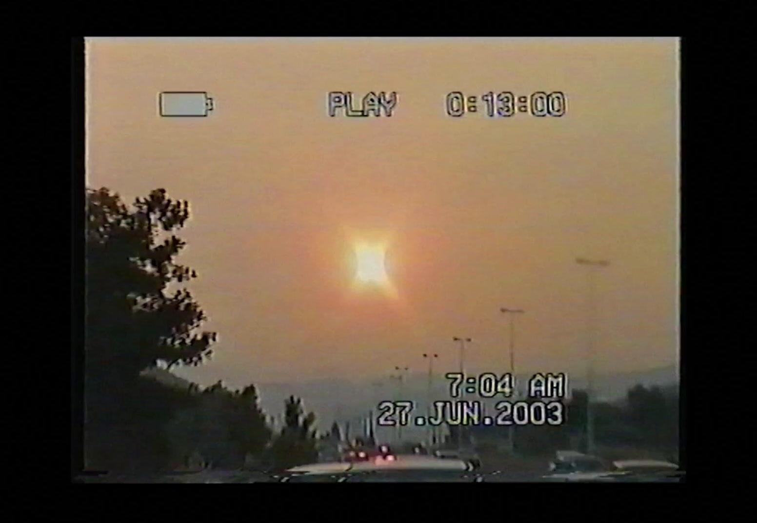 the sun is setting over a city street