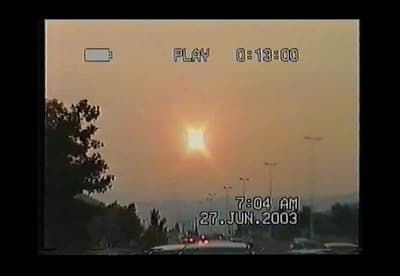 the sun is setting over a city street