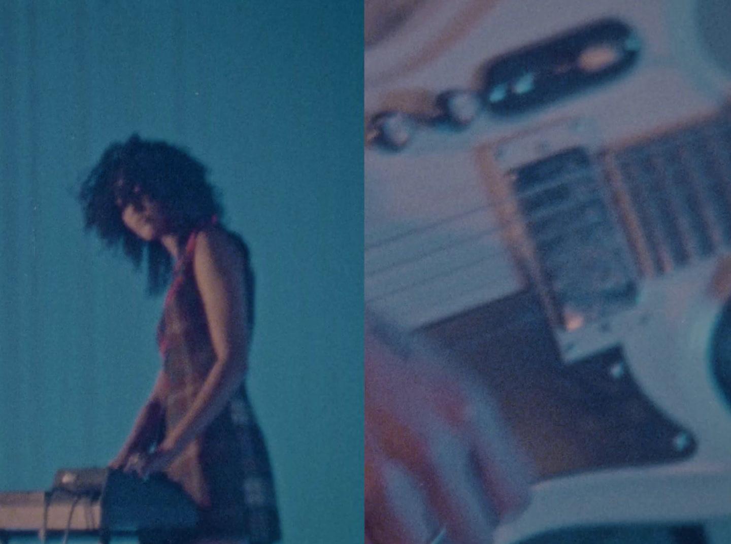 a woman standing next to a table with a guitar on it