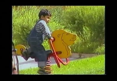 a young boy riding a yellow bear on a skateboard