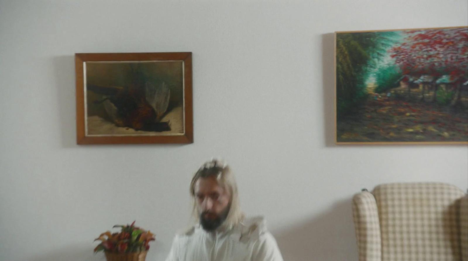 a man in a white robe is playing a video game