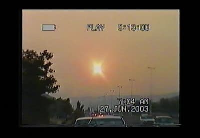 the sun is setting over a parking lot