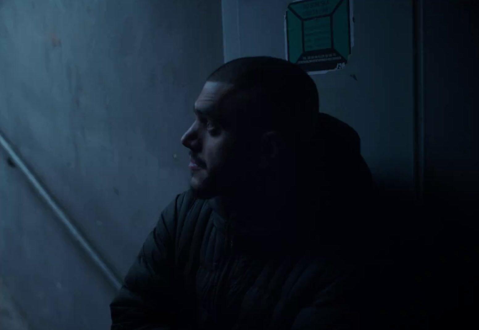 a man in a dark room looking at something