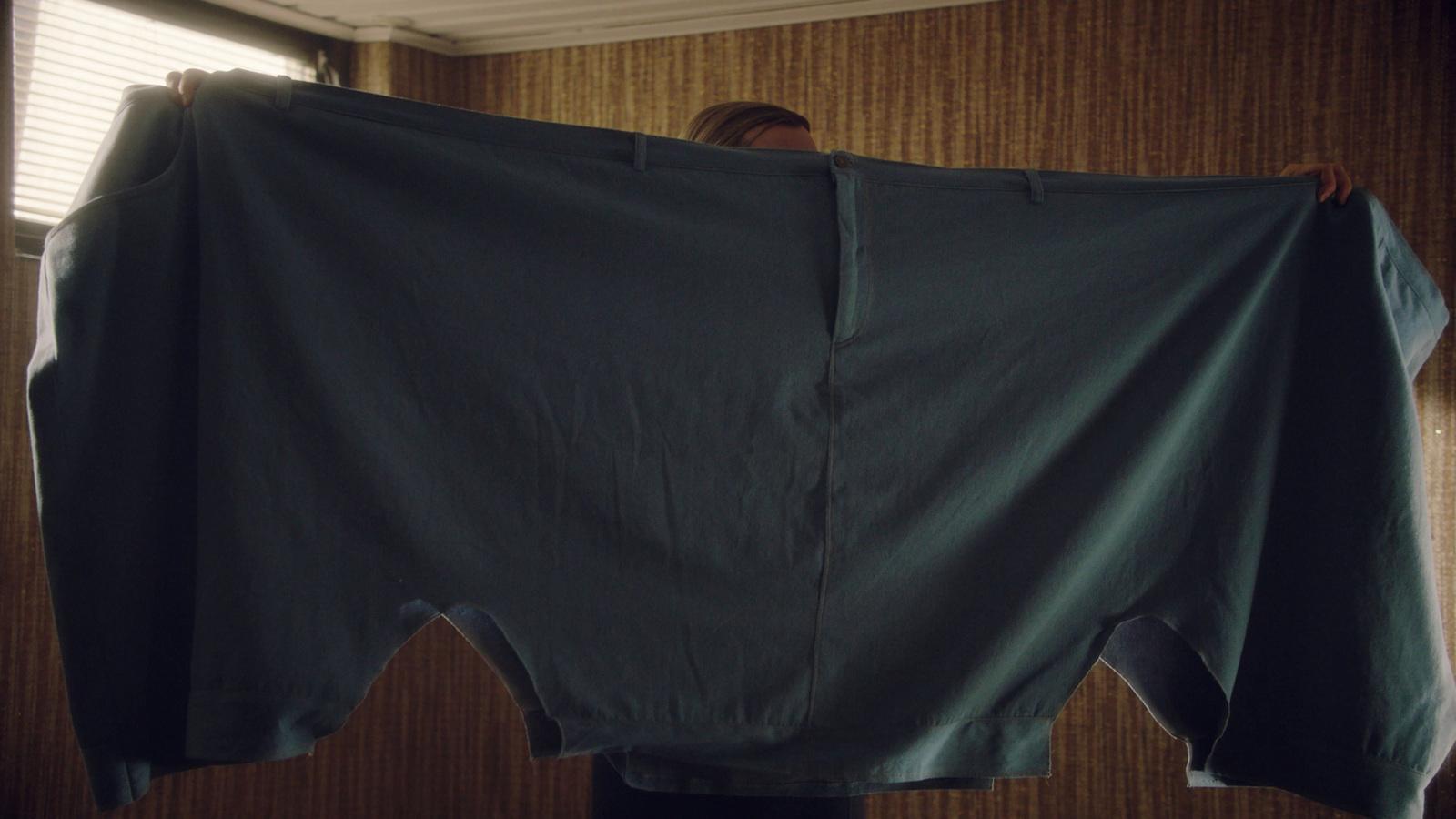 a person is holding up a large piece of cloth