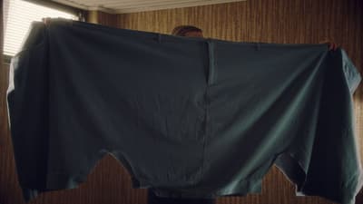 a person is holding up a large piece of cloth