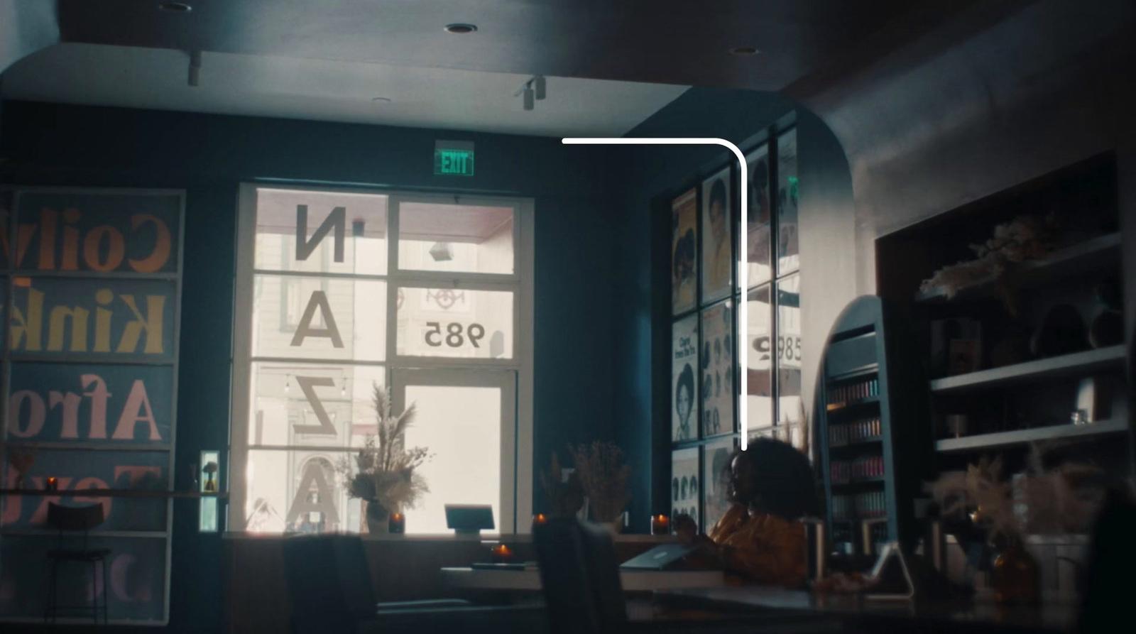 a person sitting at a table in front of a window