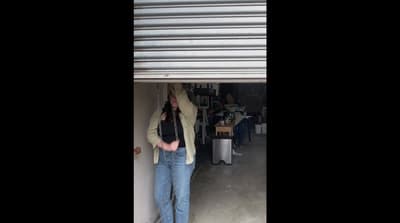 a woman standing in front of a garage door