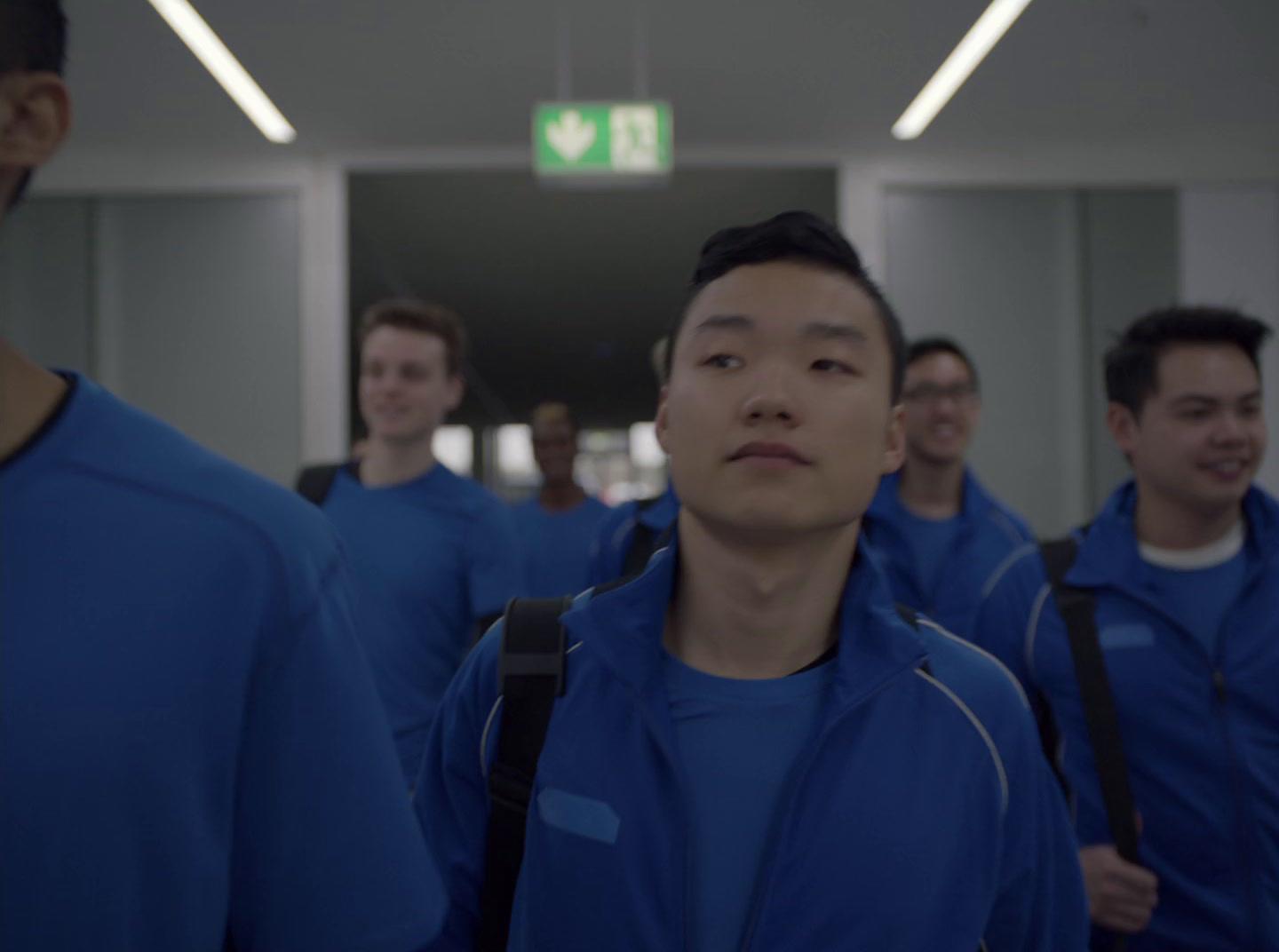 a group of men walking down a hallway