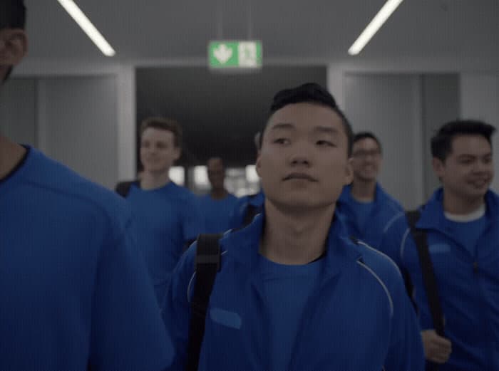 a group of men walking down a hallway