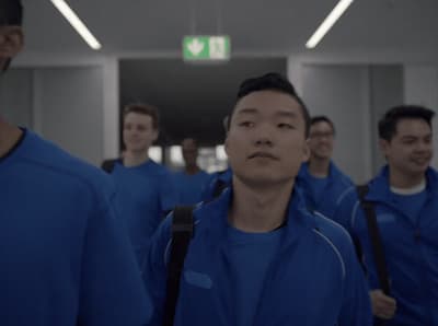 a group of men walking down a hallway