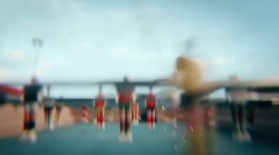 a blurry photo of a person standing on a pier