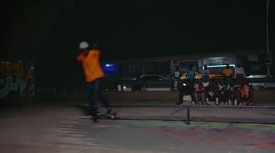a man riding a skateboard on top of a metal rail