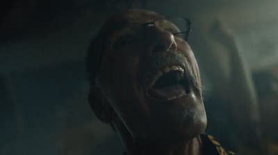 a man with his mouth open in the dark