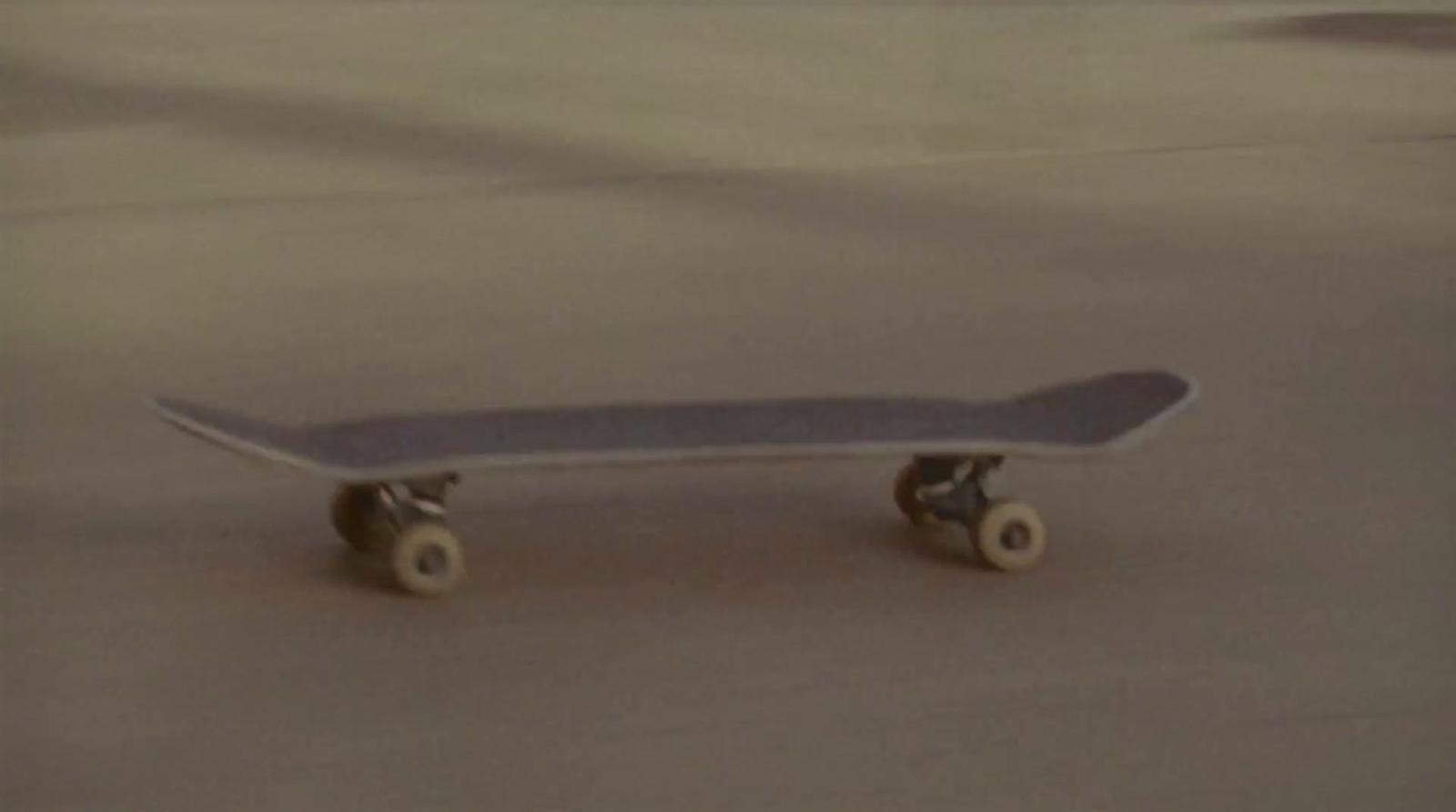 a skateboard sitting on top of a cement floor