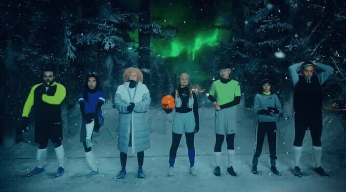 a group of people standing next to each other in the snow
