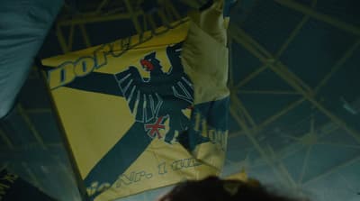 a person holding a yellow and black flag