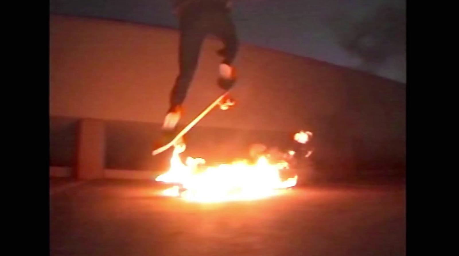 a person jumping a skate board over a fire