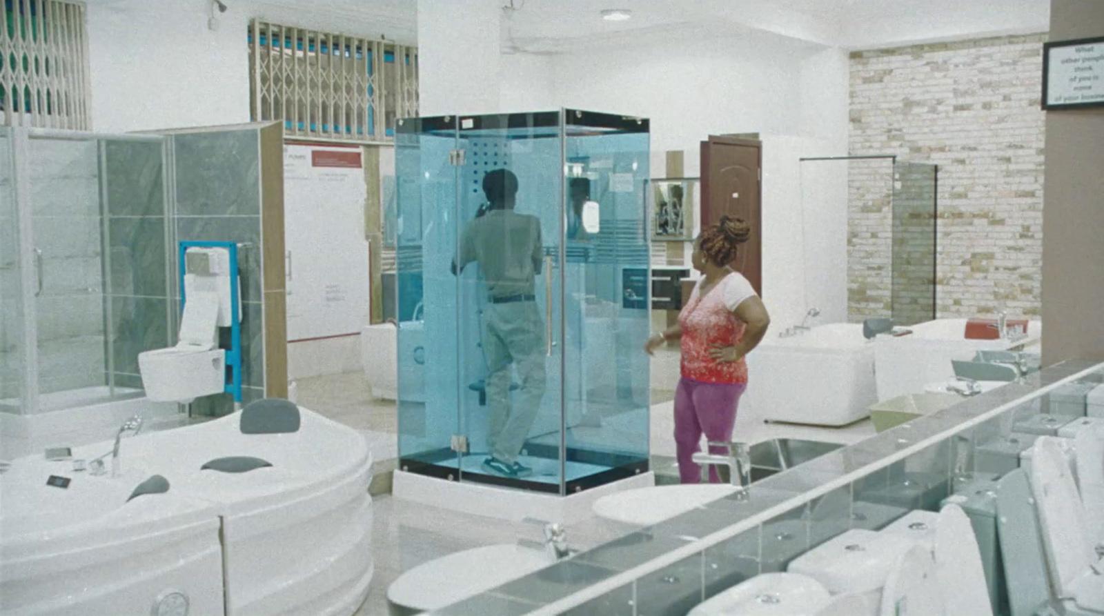 a woman standing in a bathroom with a glass shower