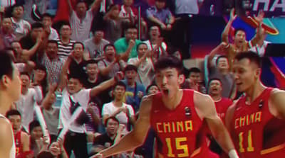 a group of men standing on top of a basketball court