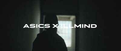 a person standing in a dark hallway with the words asicsxlimind over