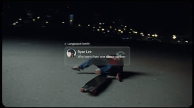 a man riding a skateboard down a street at night