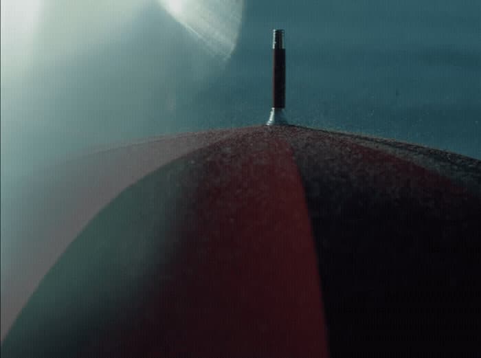 a close up of a red umbrella with a sky background