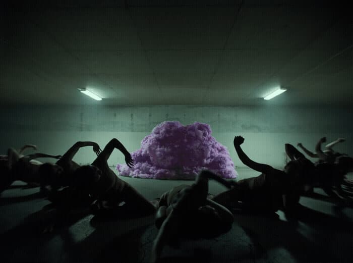 a group of people laying on the ground in a room
