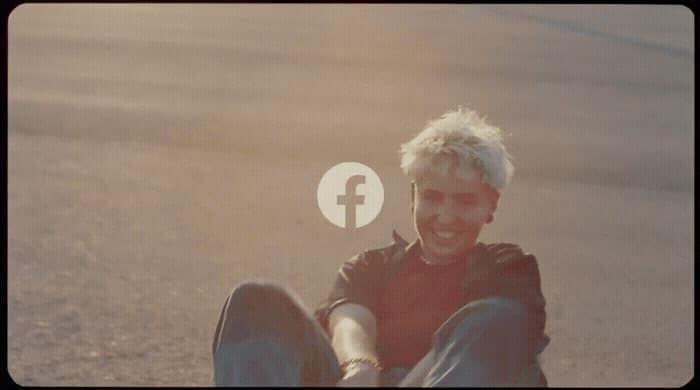 a man sitting on the ground with a facebook logo above his head