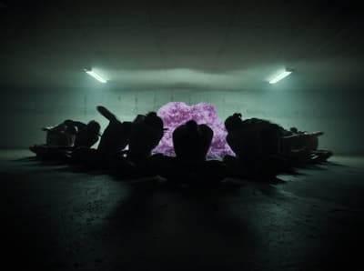 a group of people sitting in a dark room
