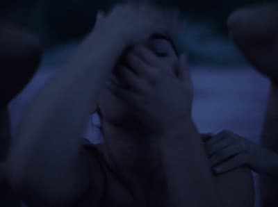 a woman covering her face with her hands