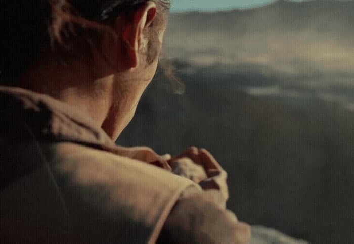 a man standing in front of a mountain