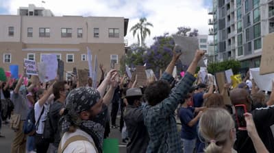 a group of people holding up signs in the air