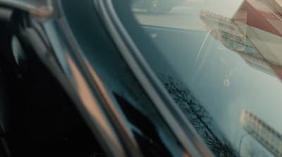 a close up of a car window with a stop sign
