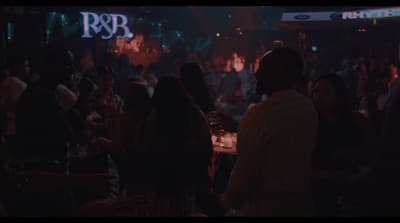 a group of people standing around a bar