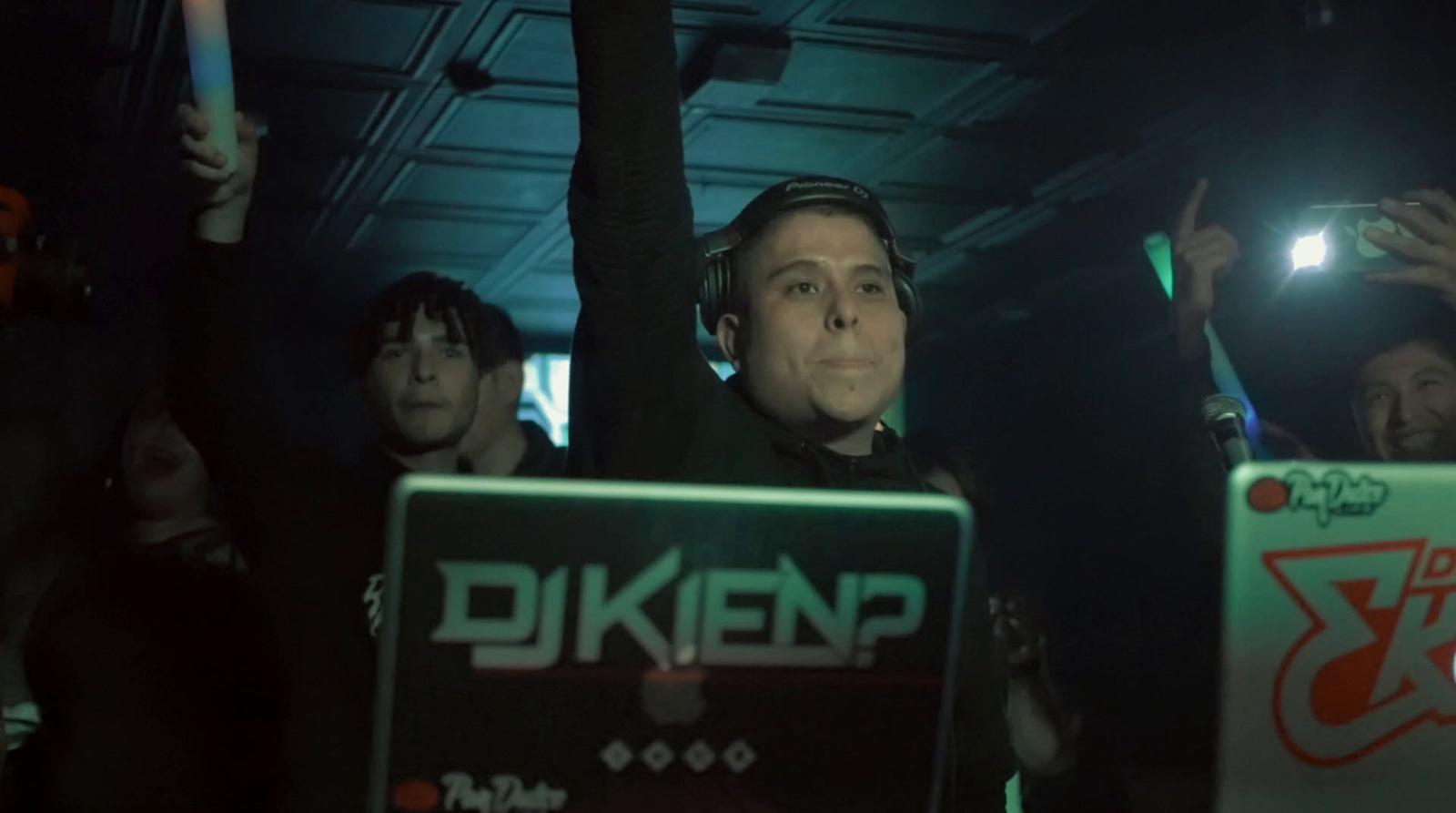 a man holding a laptop in front of a crowd of people