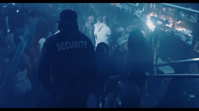 a group of people standing around a bar