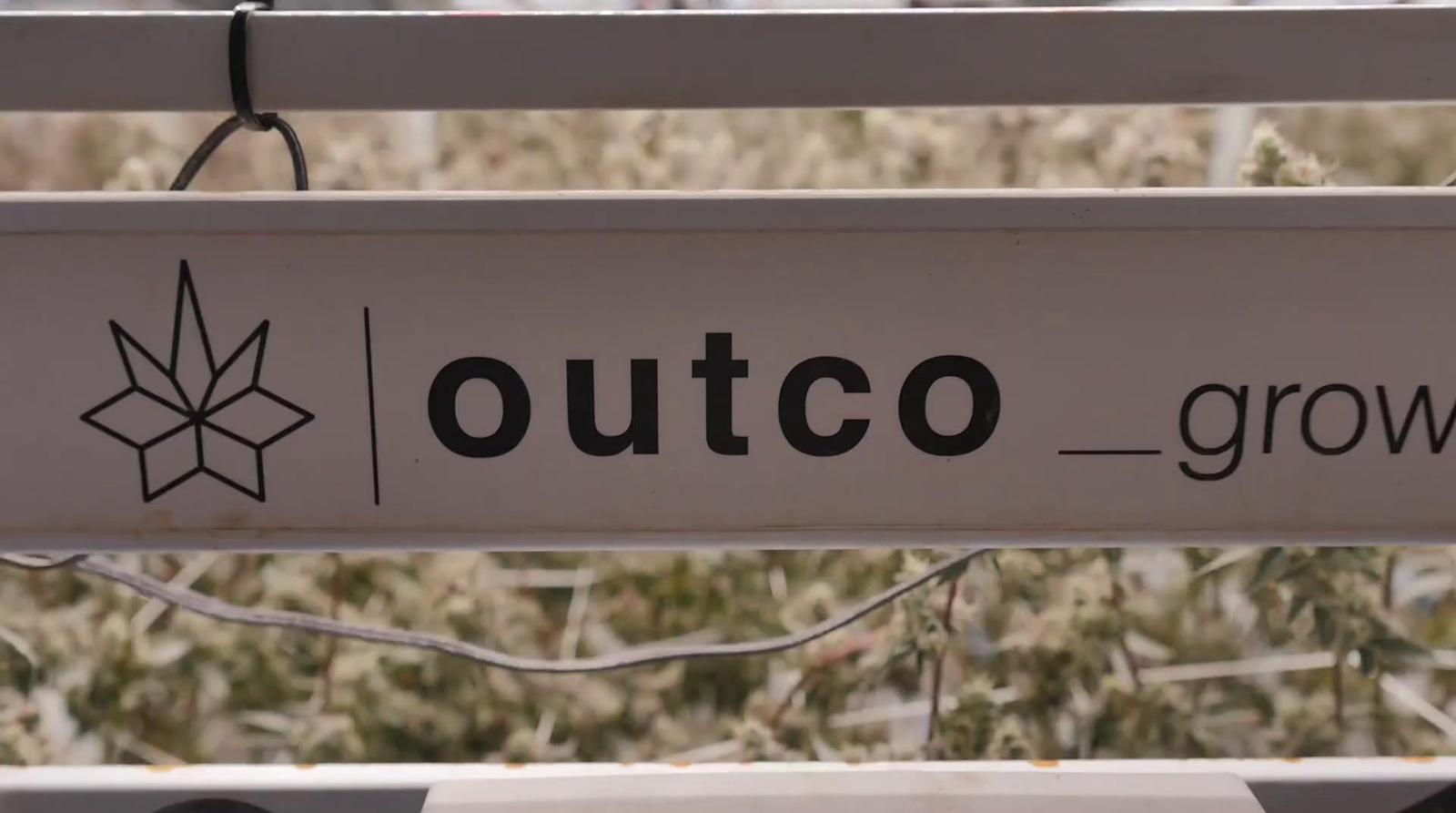 a sign that says outco grown on it