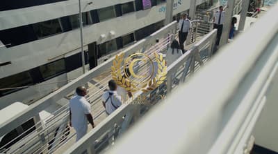 a group of people walking across a bridge