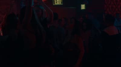 a group of people standing in a dark room