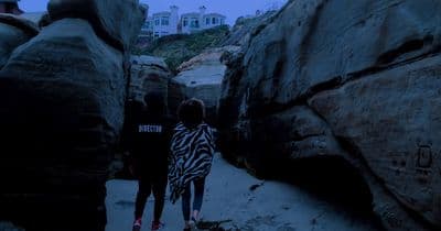 a couple of people that are walking down a path