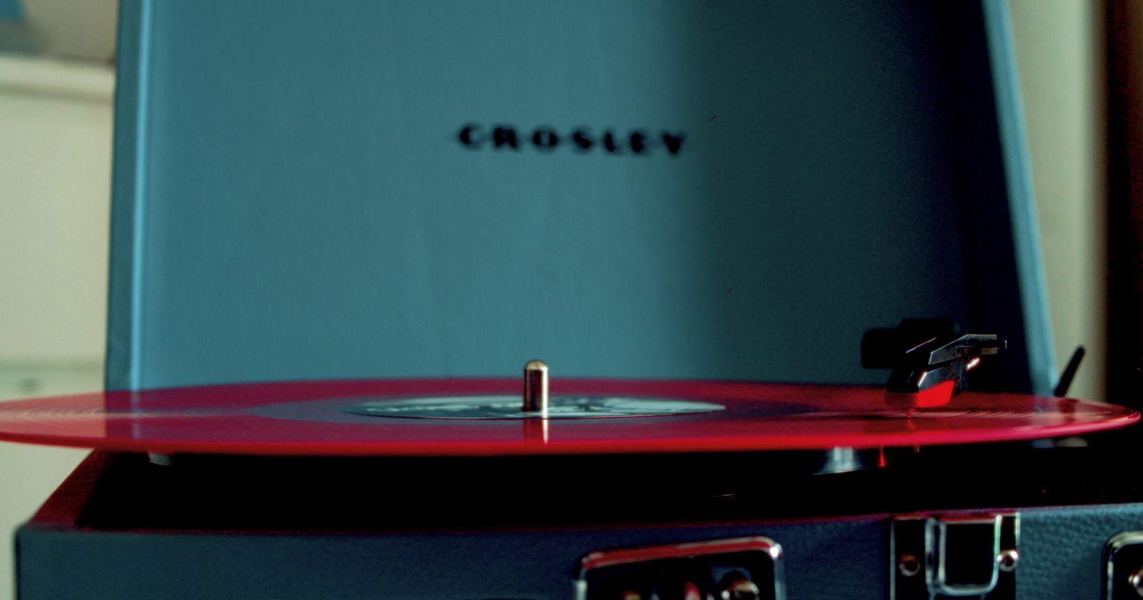 a record player sitting on top of a suitcase