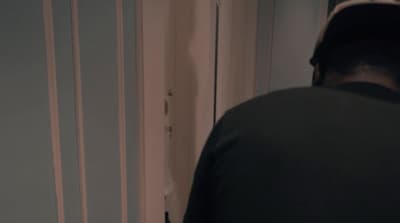 a man standing in front of a door in a room