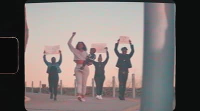 a group of people standing on top of a sidewalk