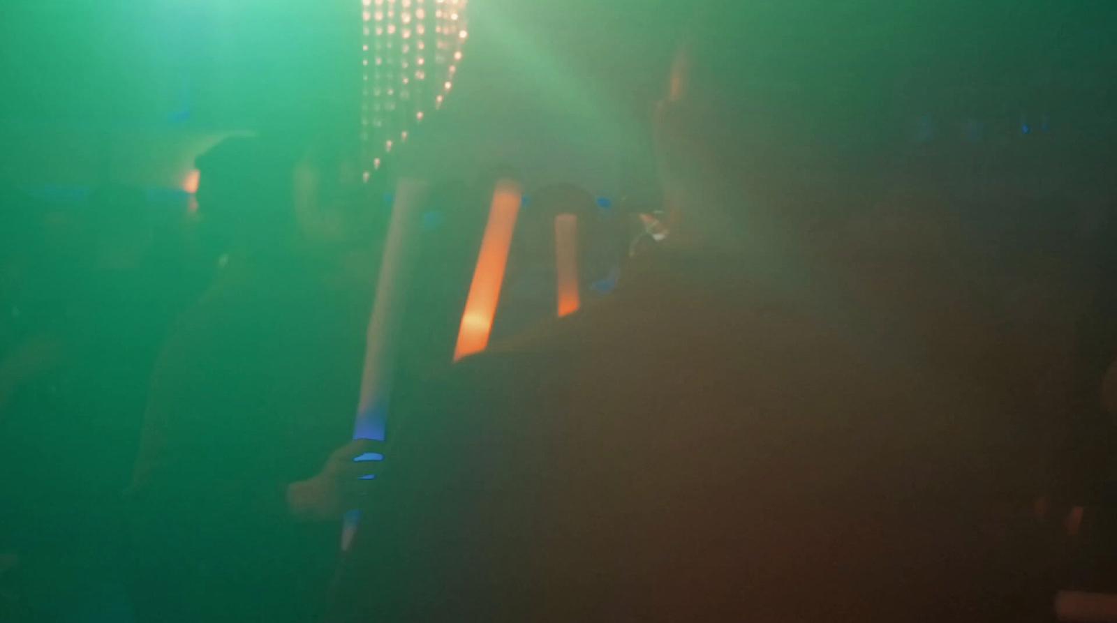a group of people standing around in a dark room