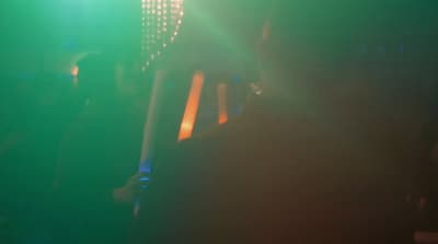 a group of people standing around in a dark room