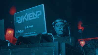 a man wearing a helmet standing in front of a sign