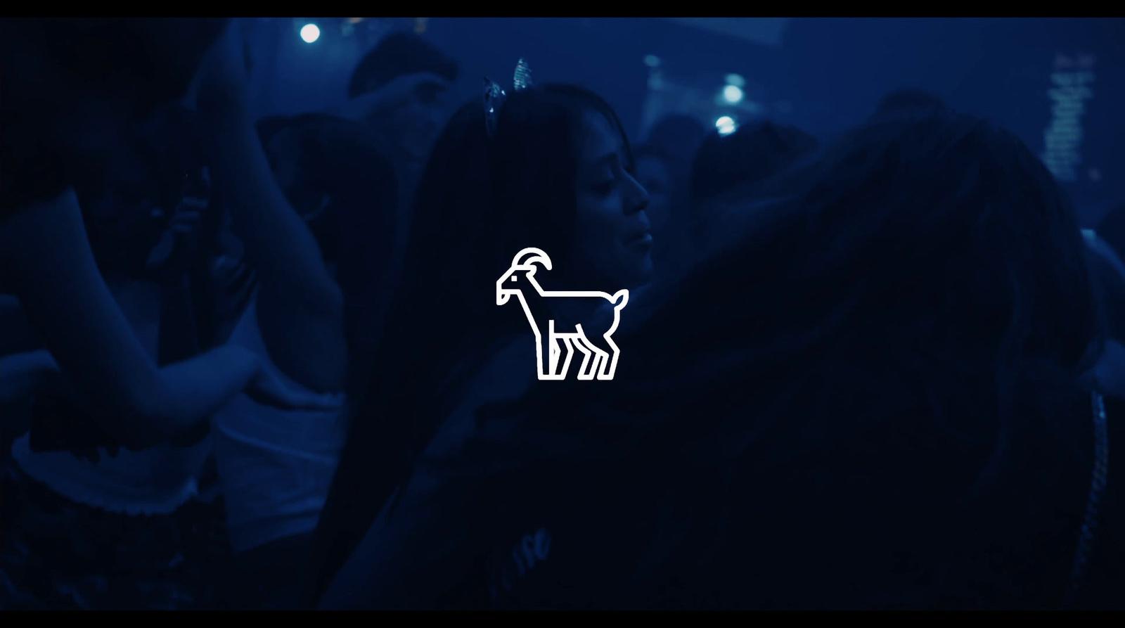 a group of people standing around a room with a dog sticker on it
