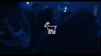 a group of people standing around a room with a dog sticker on it